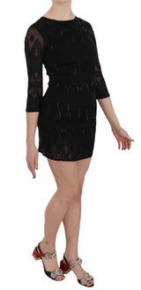 Élégant mini robe de soie noire avec paillettes