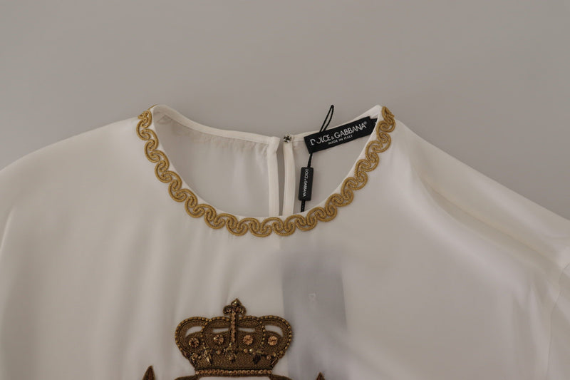 Elegante blusa de seda con bordado de corona dorada